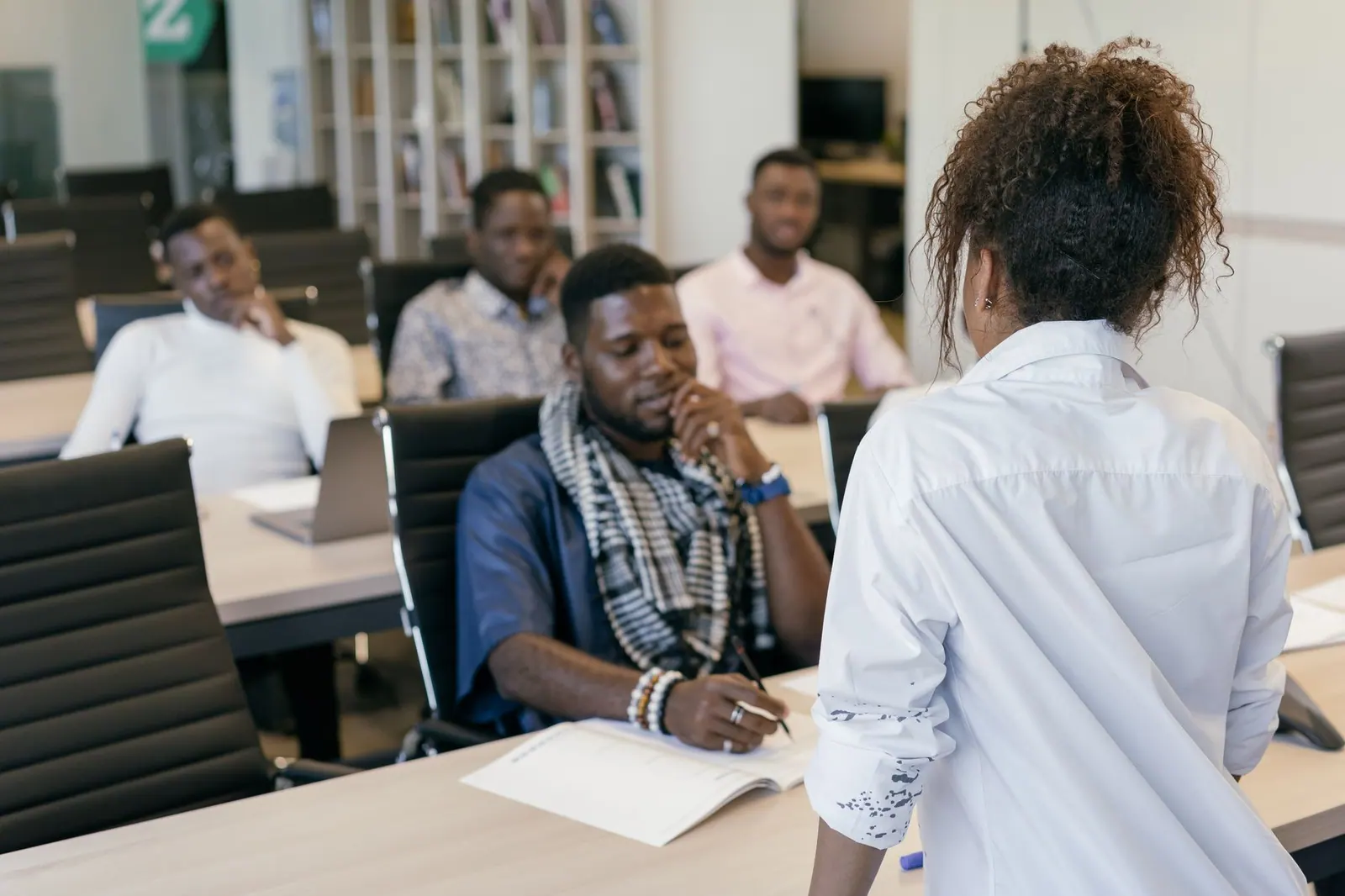 A group of professionals engaging in a training session in a modern office setting.