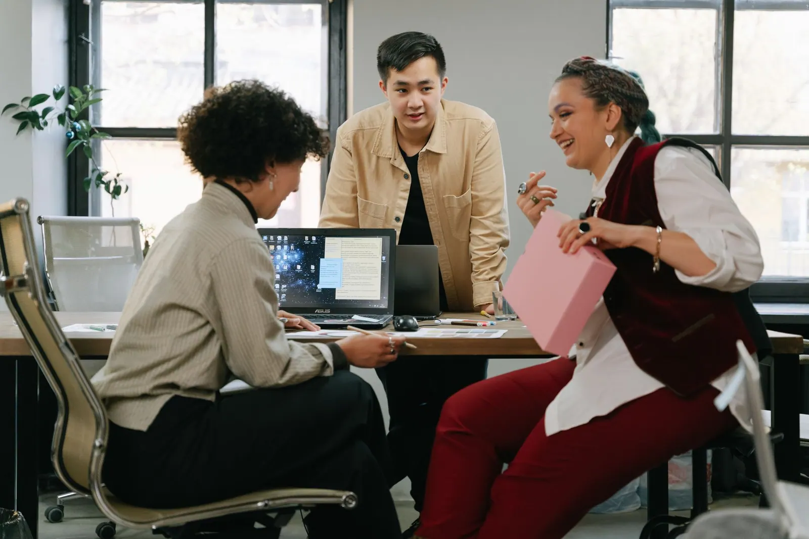 Diverse team collaborating in a modern office setting with a focus on creativity and teamwork.
