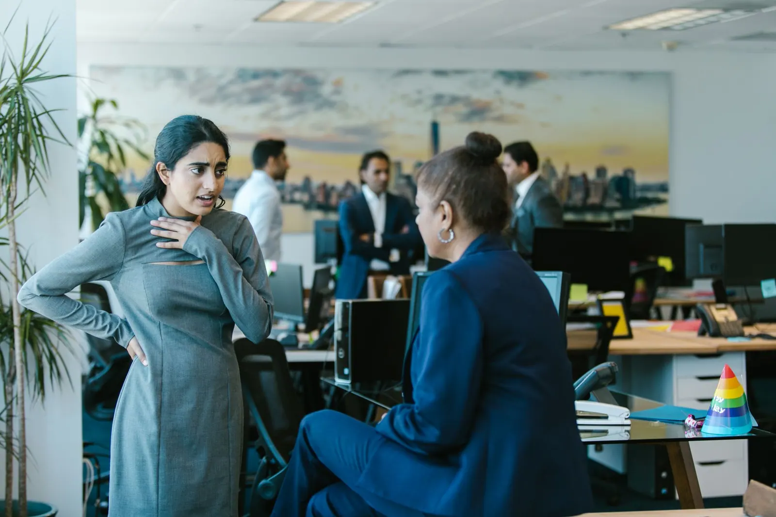 Employees engage in a lively discussion in a contemporary office setting.